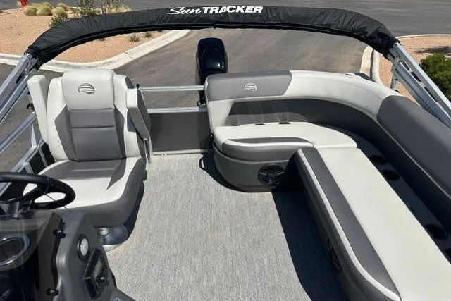 Slide: The Image of 2026 Sun Tracker Bass Buggy 16 XL Select pontoon boat interior with seating and steering console. - 13