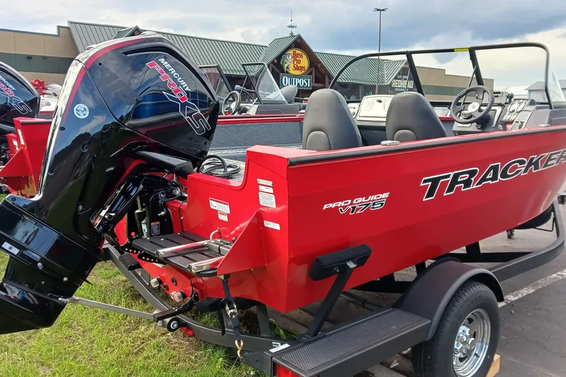 The Image of 2026 Tracker Pro Guide V-175 WT boat with Mercury engine, parked outside Bass Pro Shops. - 0