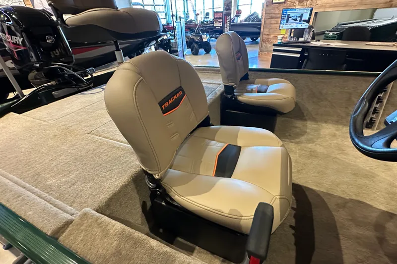 Slide: The Image of 2026 Tracker Bass Tracker Classic Limited boat interior with beige seats and steering wheel. - 44