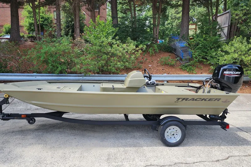 The Image of 2026 Tracker Grizzly 1648 SC boat on trailer with Mercury outboard motor. - 0