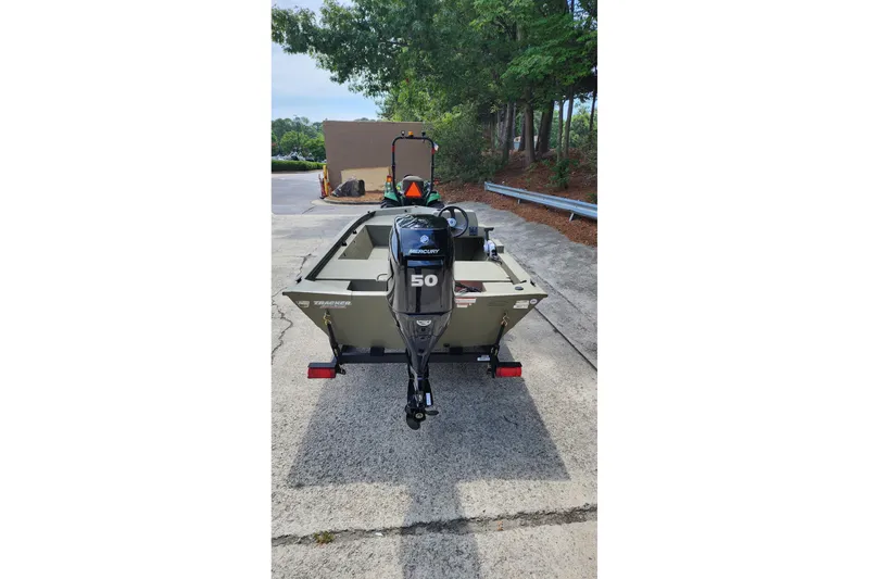 Slide: The Image of 2026 Tracker Grizzly 1648 SC boat with Mercury 50 engine, parked outdoors. - 4
