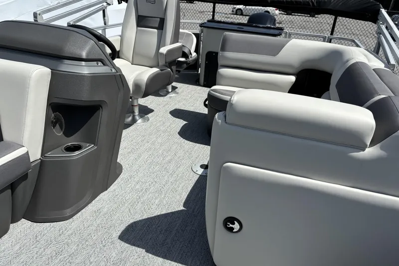 Slide: The Image of 2026 Sun Tracker Fishin' Barge 20 DLX interior with plush seating and modern console design. - 6