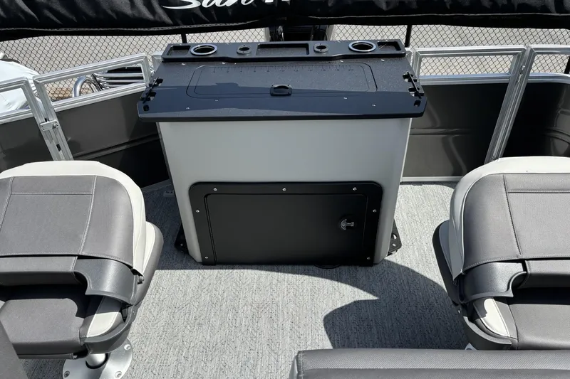 Slide: The Image of 2026 Sun Tracker Fishin' Barge 20 DLX interior with seating and storage console. - 7