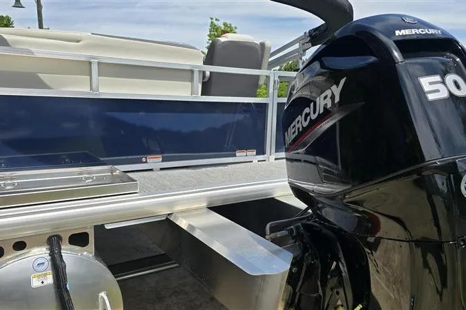 Slide: The Image of 2026 Sun Tracker Bass Buggy 16 XL Select with Mercury 50 engine, side view. - 3