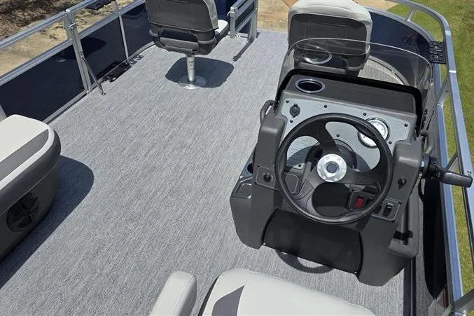 Slide: The Image of 2026 Sun Tracker Bass Buggy 16 XL Select pontoon boat interior with steering console and seating. - 5