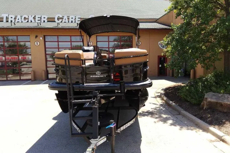 Slide: The Image of 2026 Regency 230 DL boat parked outside Tracker Care facility. - 65