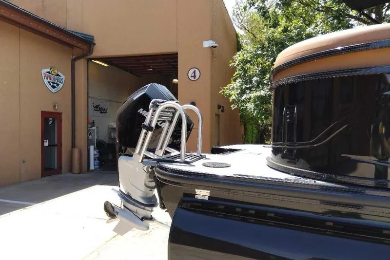 Slide: The Image of 2026 Regency 230 DL boat with Mercury engine outside a workshop. - 68