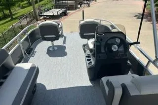Slide: The Image of 2026 Sun Tracker Bass Buggy 16 XL Select pontoon boat interior with seating and steering console. - 5