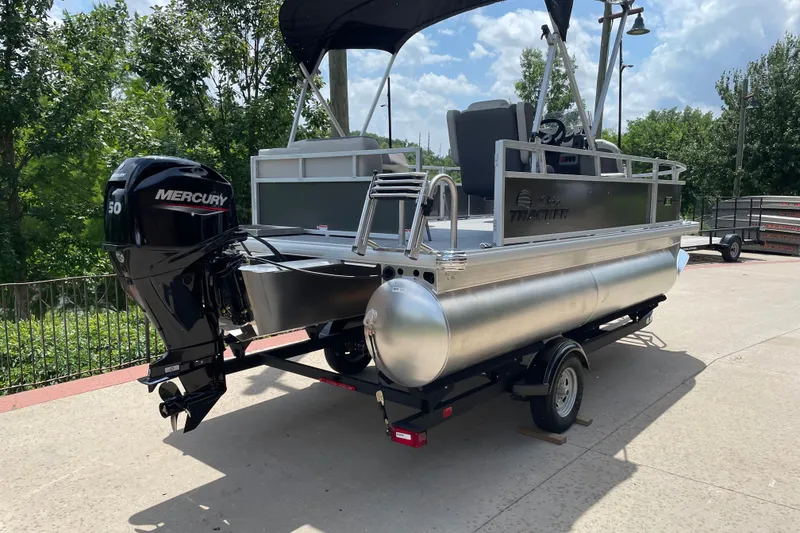 Slide: The Image of 2026 Sun Tracker Bass Buggy 16 XL Select pontoon boat with Mercury 50 engine on trailer. - 2