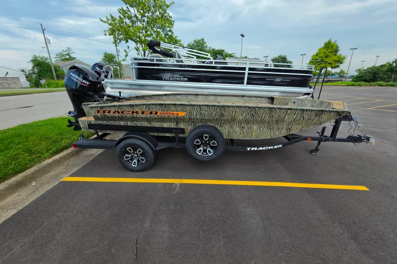 The Image of 2026 Tracker Grizzly 1756 T Marsh boat on trailer in parking lot. - 0