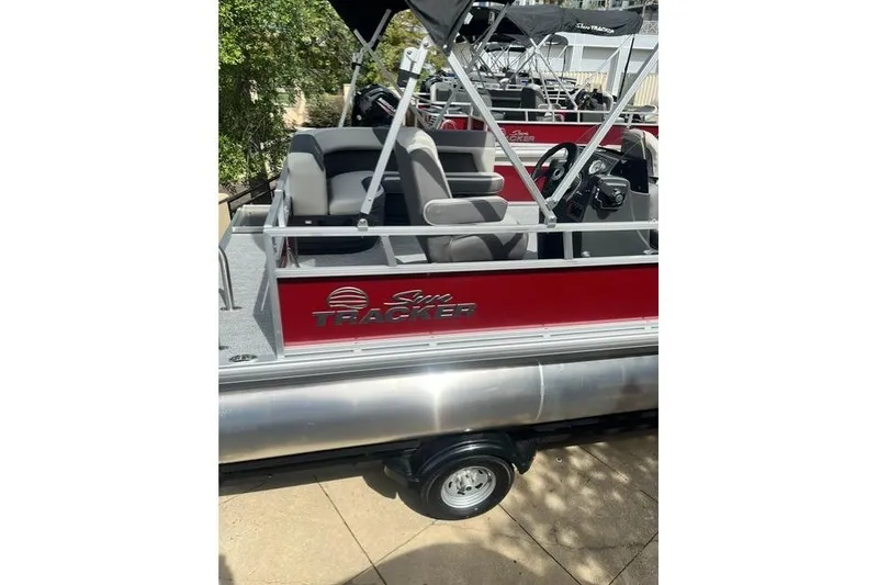 Slide: The Image of 2026 Sun Tracker Bass Buggy 16 XL Select pontoon boat with red exterior and seating. - 4