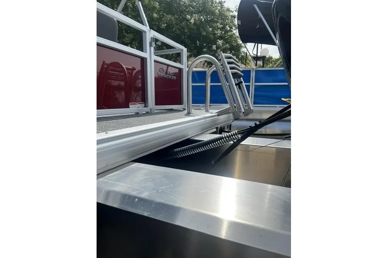 Slide: The Image of 2026 Sun Tracker Bass Buggy 16 XL Select pontoon boat, featuring sleek aluminum and sturdy railings. - 7