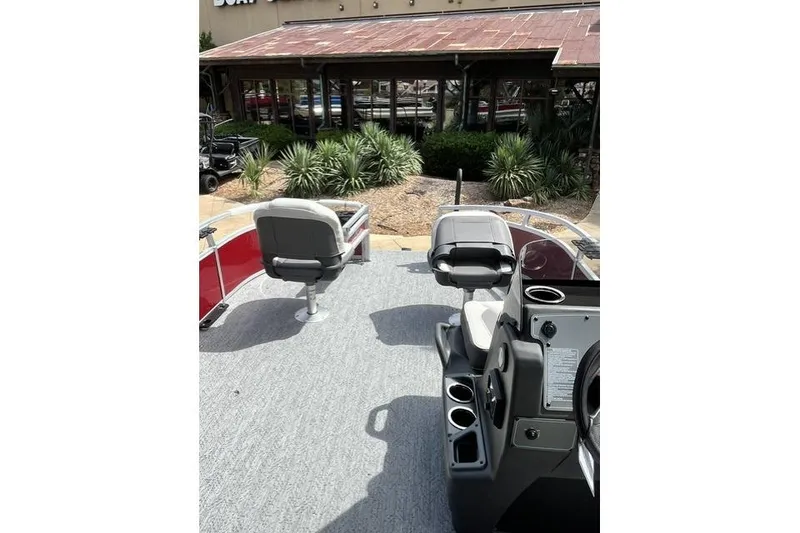 The Image of 2026 Sun Tracker Bass Buggy 16 XL Select pontoon boat interior with seating and console. - 0