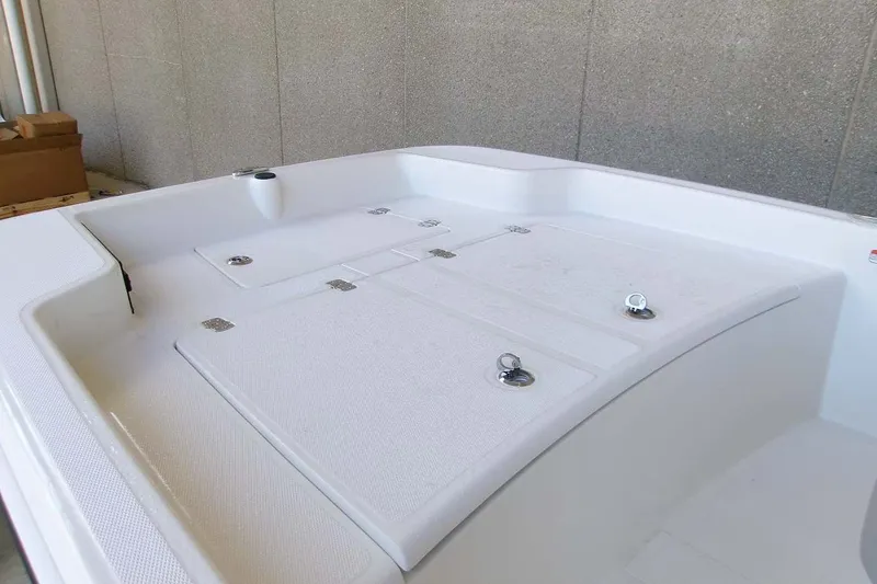 Slide: The Image of 2026 Mako Pro Skiff 15 CC boat interior with storage compartments and sleek design. - 9