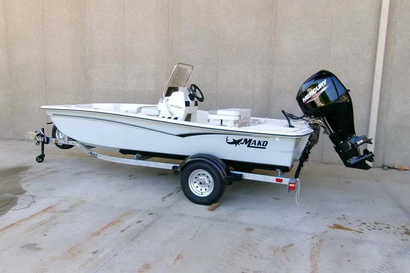 Slide: The Image of 2026 Mako Pro Skiff 15 CC boat on trailer, featuring Mercury outboard motor. - 1