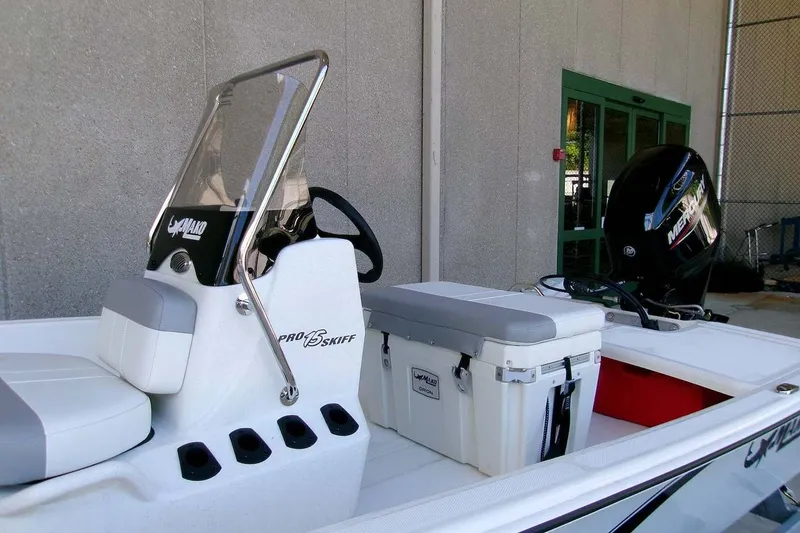 Slide: The Image of 2026 Mako Pro Skiff 15 CC boat with console and Mercury outboard motor. - 13