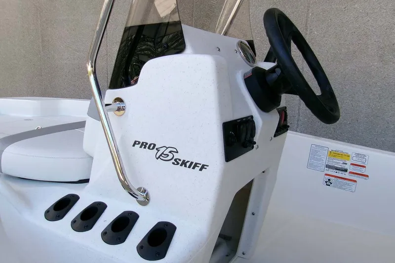Slide: The Image of 2026 Mako Pro Skiff 15 CC boat console with steering wheel and controls. - 11