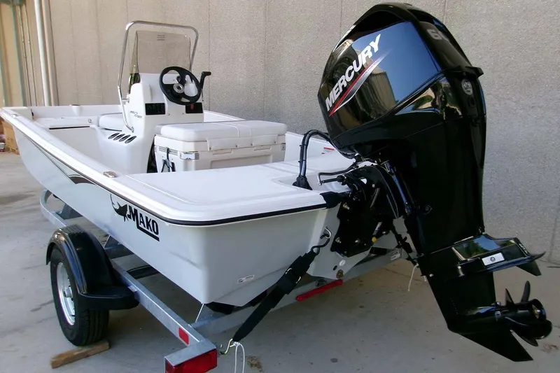 Slide: The Image of 2026 Mako Pro Skiff 15 CC boat with Mercury engine on trailer. - 4