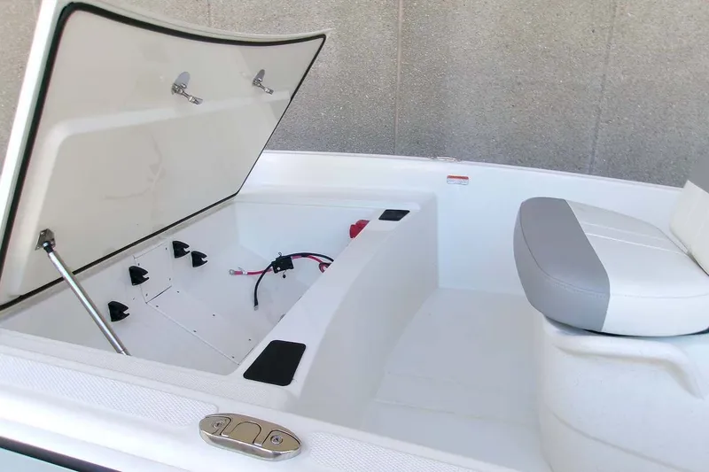 Slide: The Image of 2026 Mako Pro Skiff 15 CC boat interior with open storage compartment and seating. - 10