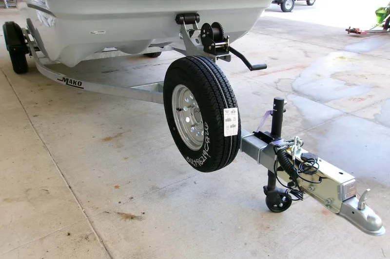 Slide: The Image of 2026 Mako Pro Skiff 15 CC trailer with wheel and hitch on concrete surface. - 7