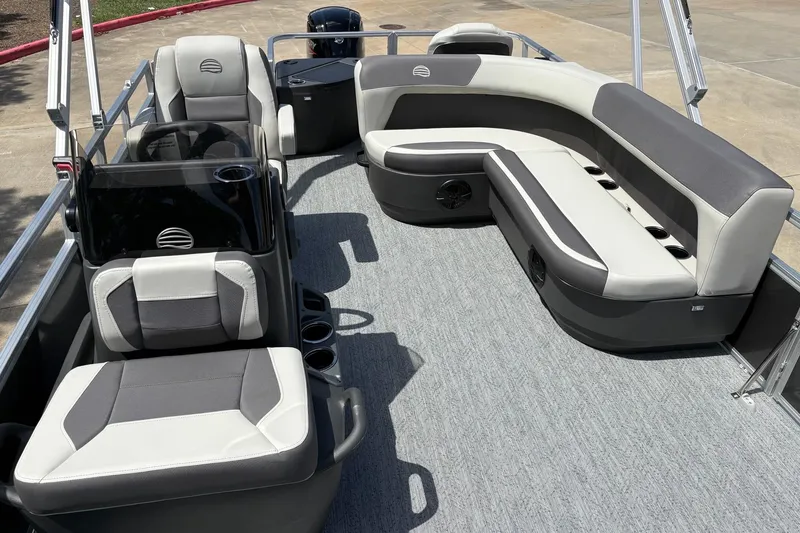 Slide: The Image of 2026 Sun Tracker Bass Buggy 18 DLX pontoon boat interior with gray seating and carpet. - 4