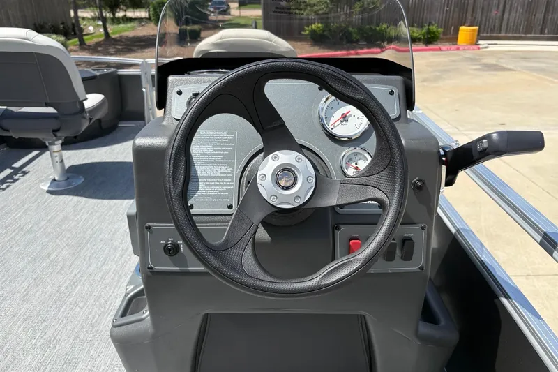 Slide: The Image of 2026 Sun Tracker Bass Buggy 18 DLX steering console with gauges and controls. - 5