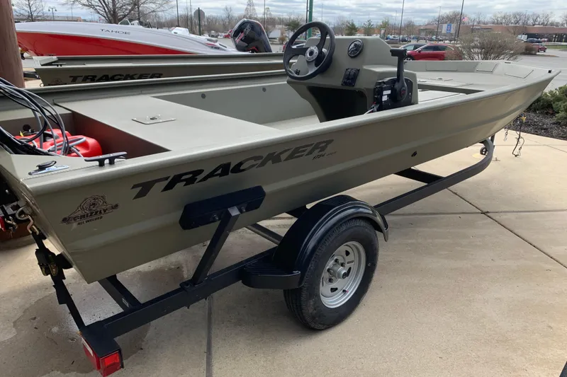 Slide: The Image of 2026 Tracker Grizzly 1754 SC boat on trailer, parked outdoors. - 4