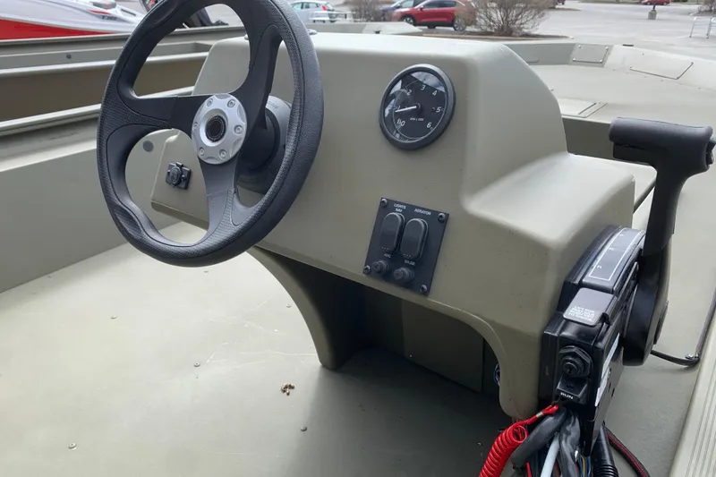 Slide: The Image of Steering console of 2026 Tracker Grizzly 1754 SC boat with controls and gauge. - 3