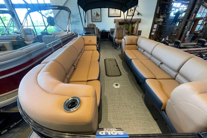 Slide: The Image of Luxurious interior of 2026 Regency 250 DL pontoon boat with tan seating and spacious layout. - 1