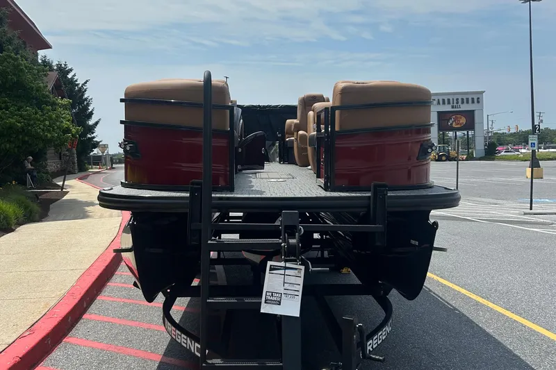 Slide: The Image of 2026 Regency 250 DL pontoon boat on trailer in parking lot, sunny day. - 3