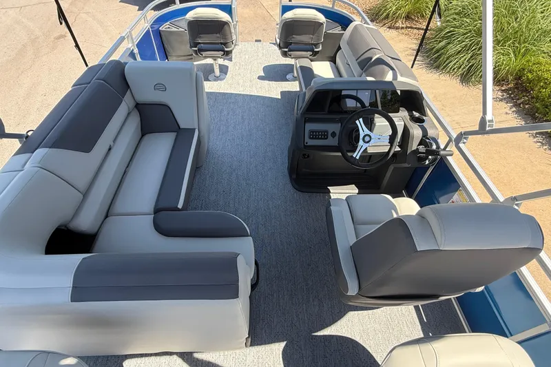 Slide: The Image of 2026 Sun Tracker Fishin' Barge 20 DLX interior with plush seating and modern helm. - 6