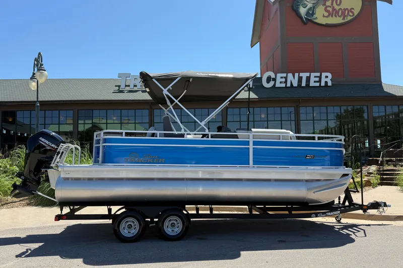 Slide: The Image of 2026 Sun Tracker Fishin' Barge 20 DLX pontoon boat displayed outside a retail center. - 8