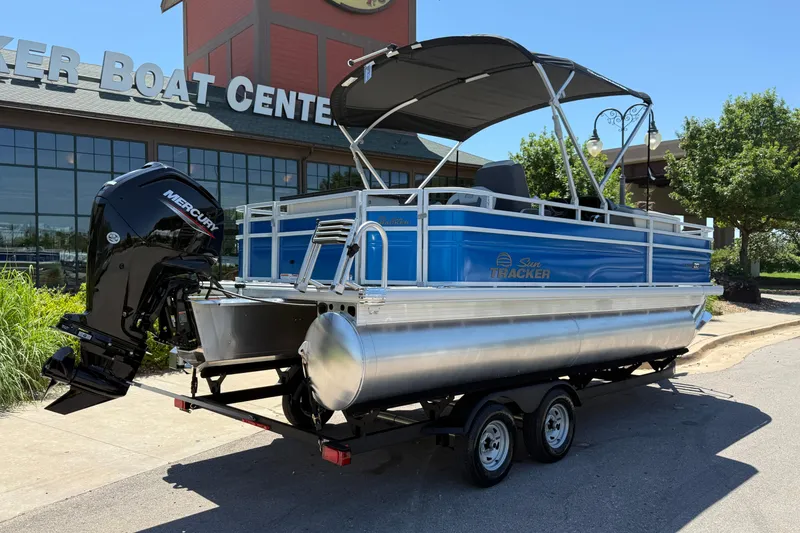 Slide: The Image of 2026 Sun Tracker Fishin' Barge 20 DLX pontoon boat on trailer outside dealership. - 9