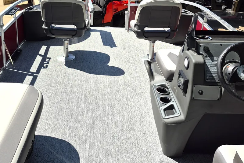 Slide: The Image of 2026 Sun Tracker Bass Buggy 18 DLX interior with seating and steering console. - 9