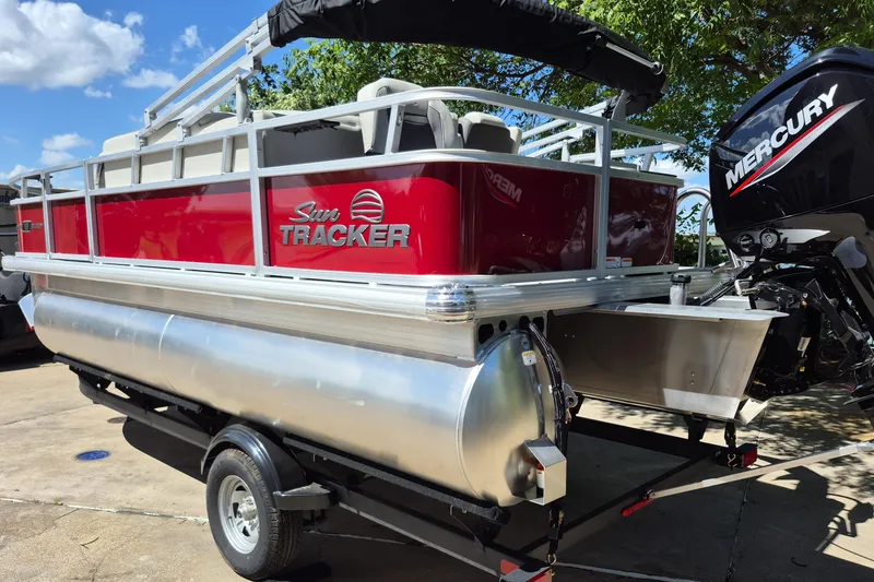 Slide: The Image of 2026 Sun Tracker Bass Buggy 18 DLX pontoon boat with Mercury engine on trailer. - 7