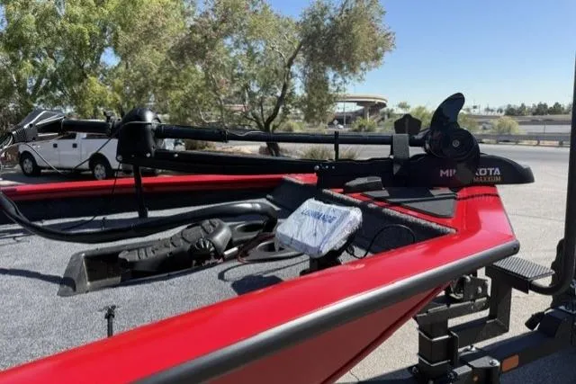 Slide: The Image of 2026 Tracker Pro Team 190 boat with red exterior, parked outdoors. - 4