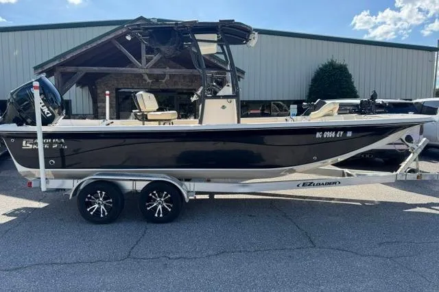The Image of 2022 Carolina Skiff 23 LS boat on trailer, parked outdoors. - 0