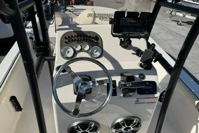 Slide: The Image of 2022 Carolina Skiff 23 LS boat dashboard with steering wheel and gauges. - 13
