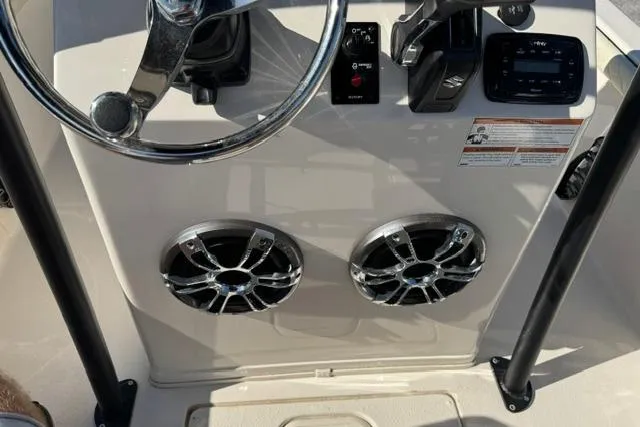 Slide: The Image of 2022 Carolina Skiff 23 LS boat console with steering wheel and dual speakers. - 14