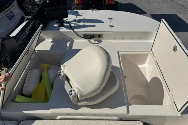 Slide: The Image of 2022 Carolina Skiff 23 LS boat interior with storage compartments and seating. - 16