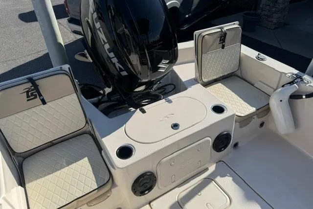 Slide: The Image of 2022 Carolina Skiff 23 LS boat interior with Suzuki engine and cushioned seating. - 17
