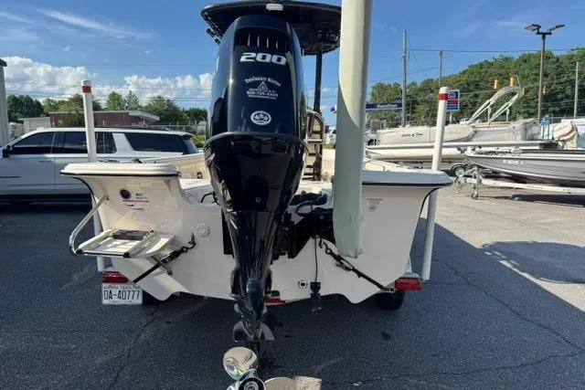 Slide: The Image of 2022 Carolina Skiff 23 LS boat with 200 horsepower motor, parked on a trailer. - 4