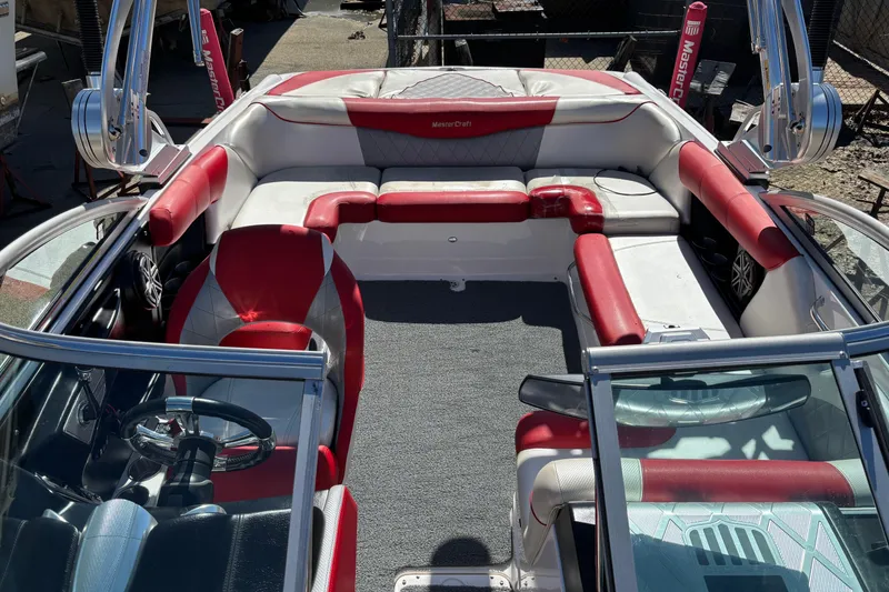 Slide: The Image of 2012 MasterCraft X-15 boat interior with red and white seating, steering wheel, and speakers. - 2