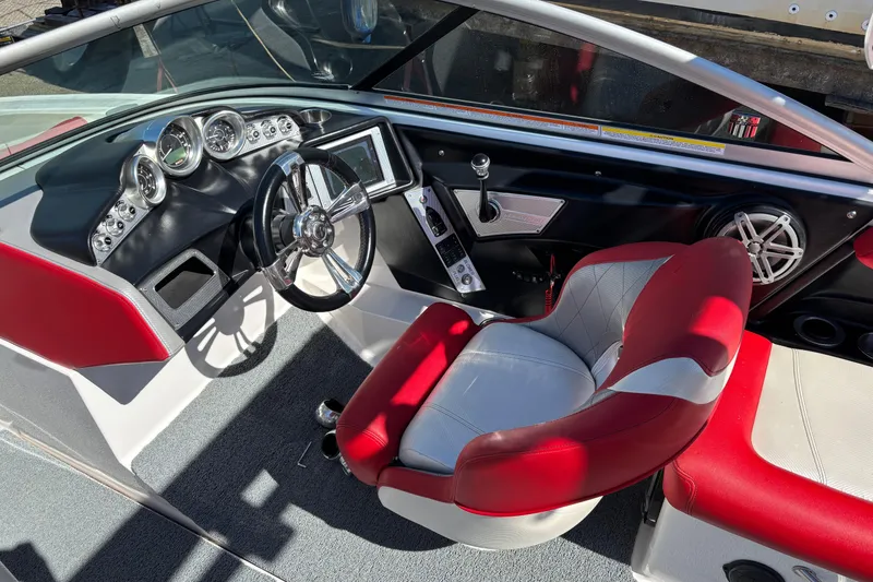 Slide: The Image of 2012 MasterCraft X-15 boat interior with red and white seating, steering wheel, and dashboard controls. - 3