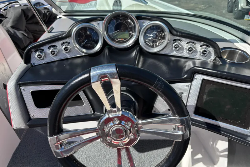 Slide: The Image of Steering wheel and dashboard of 2012 MasterCraft X-15 boat, featuring gauges and controls. - 4