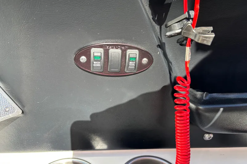 Slide: The Image of Control panel of a 2012 MasterCraft X-15 boat with switches and red safety cord. - 6