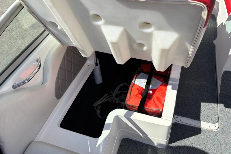 Slide: The Image of 2012 MasterCraft X-15 boat storage compartment with red life jacket and rope. - 8