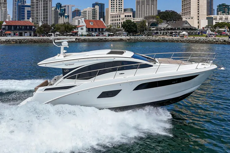 Slide: The Image of 2017 Sea Ray Sundancer 400 yacht cruising in a city harbor with skyline backdrop. - 2