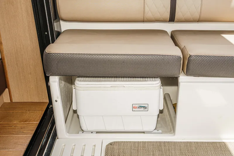 Slide: The Image of 2017 Sea Ray Sundancer 400 interior with cushioned seating and built-in storage compartment. - 30