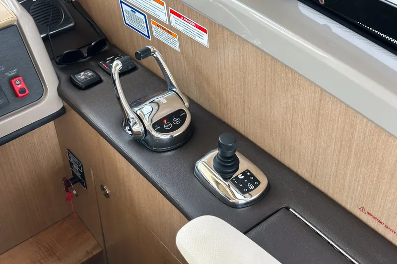 Slide: The Image of Control panel of a 2017 Sea Ray Sundancer 400 yacht, featuring throttle and joystick controls. - 29